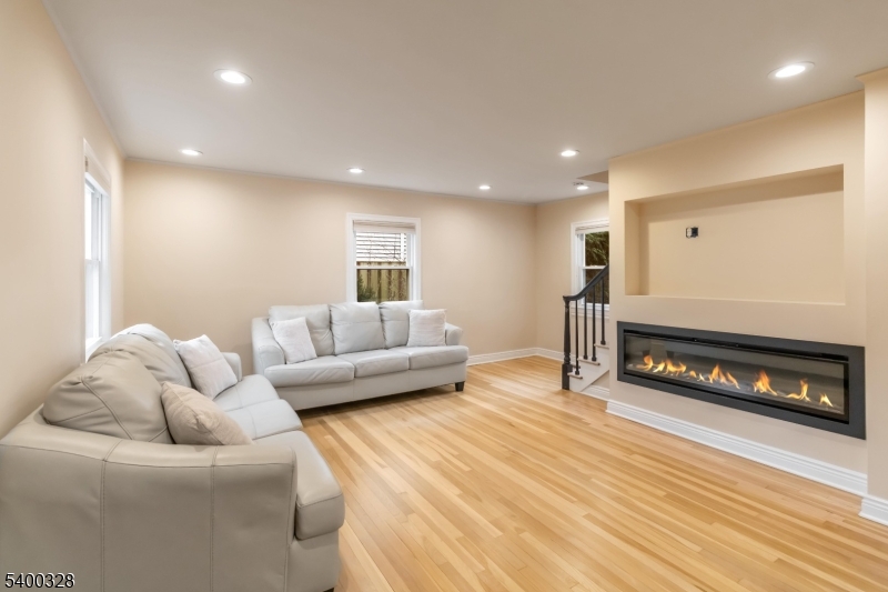 31 Sherman Avenue Hawthorne, NJ 07506 - Photo 4 of 23 a living room with furniture a couch and a fireplace