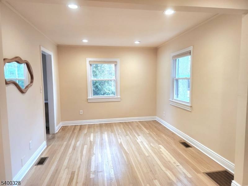 31 Sherman Avenue Hawthorne, NJ 07506 - Photo 6 of 23 a view of empty room with wooden floor and fan