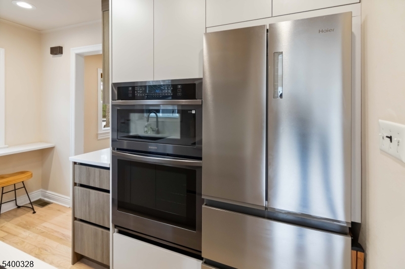 31 Sherman Avenue Hawthorne, NJ 07506 - Photo 9 of 23 a kitchen with metallic refrigerator and a stove