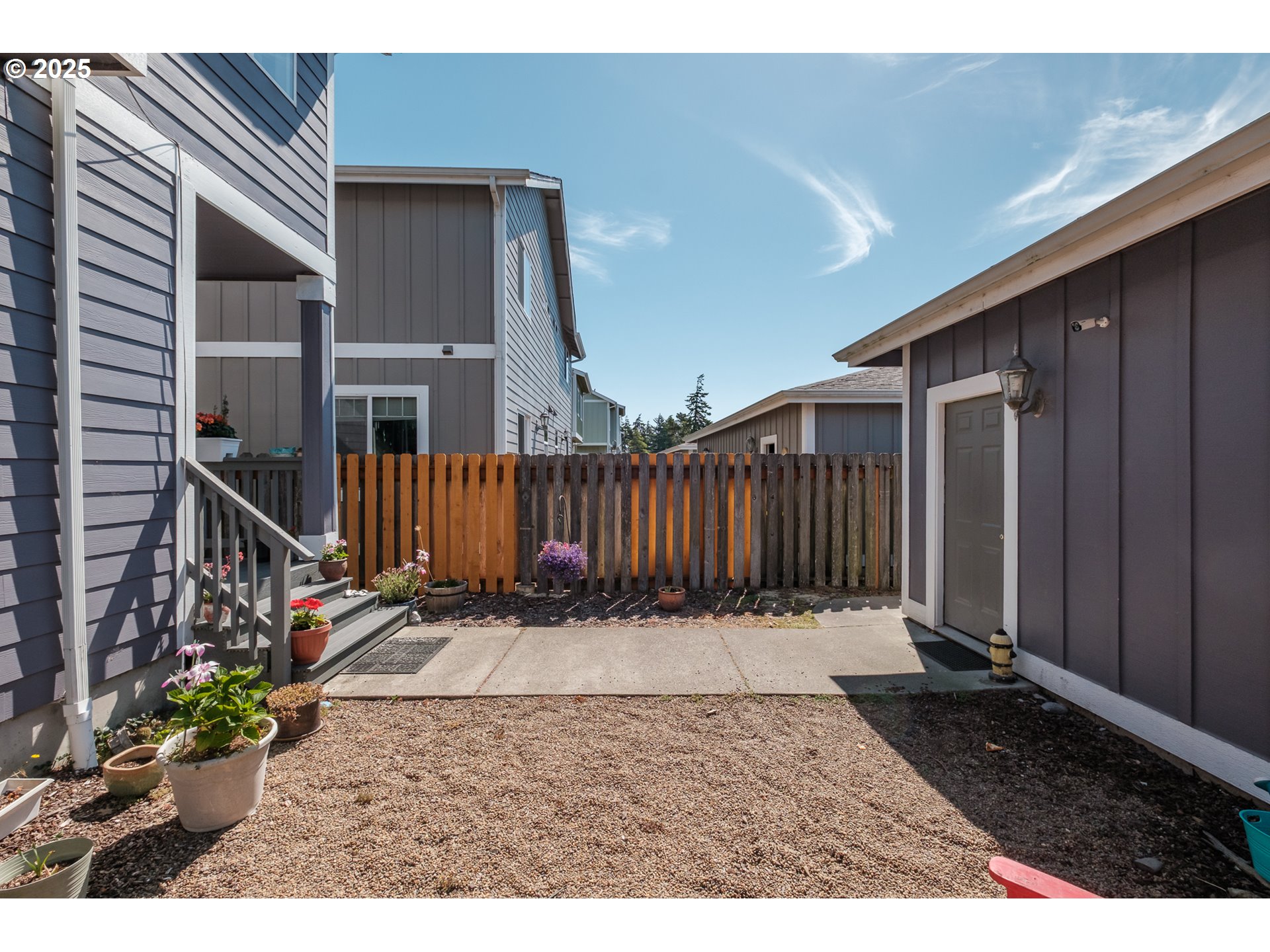 1036 9th Street Florence, OR 97439 - Photo 41 of 47 a backyard of a house with table and chairs