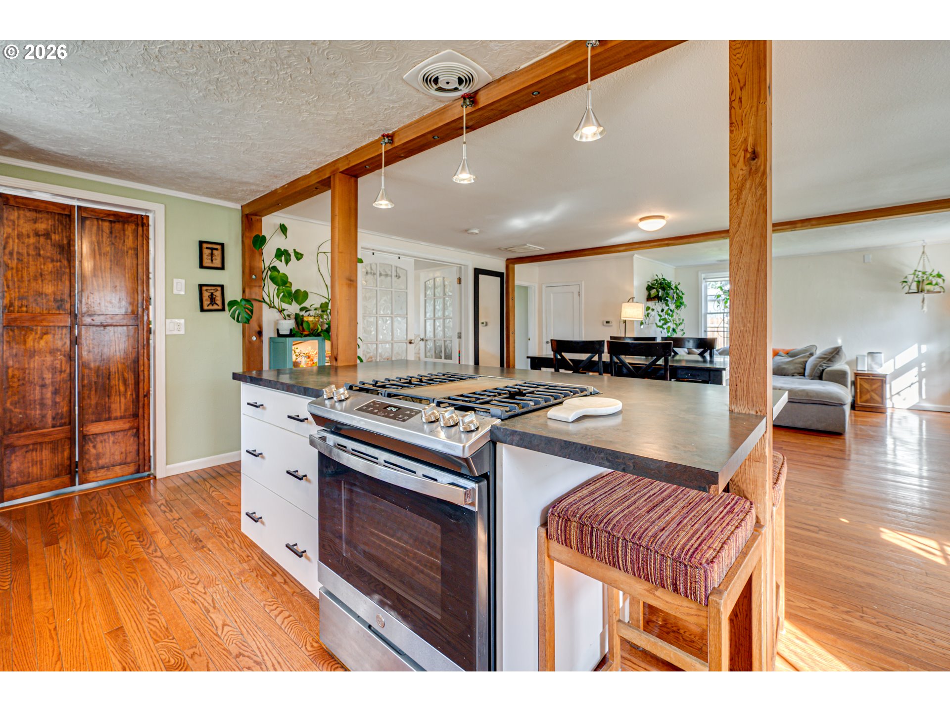 565 9th Street Washougal, WA 98671 - Photo 11 of 24 a kitchen with kitchen island a stove a sink and a refrigerator