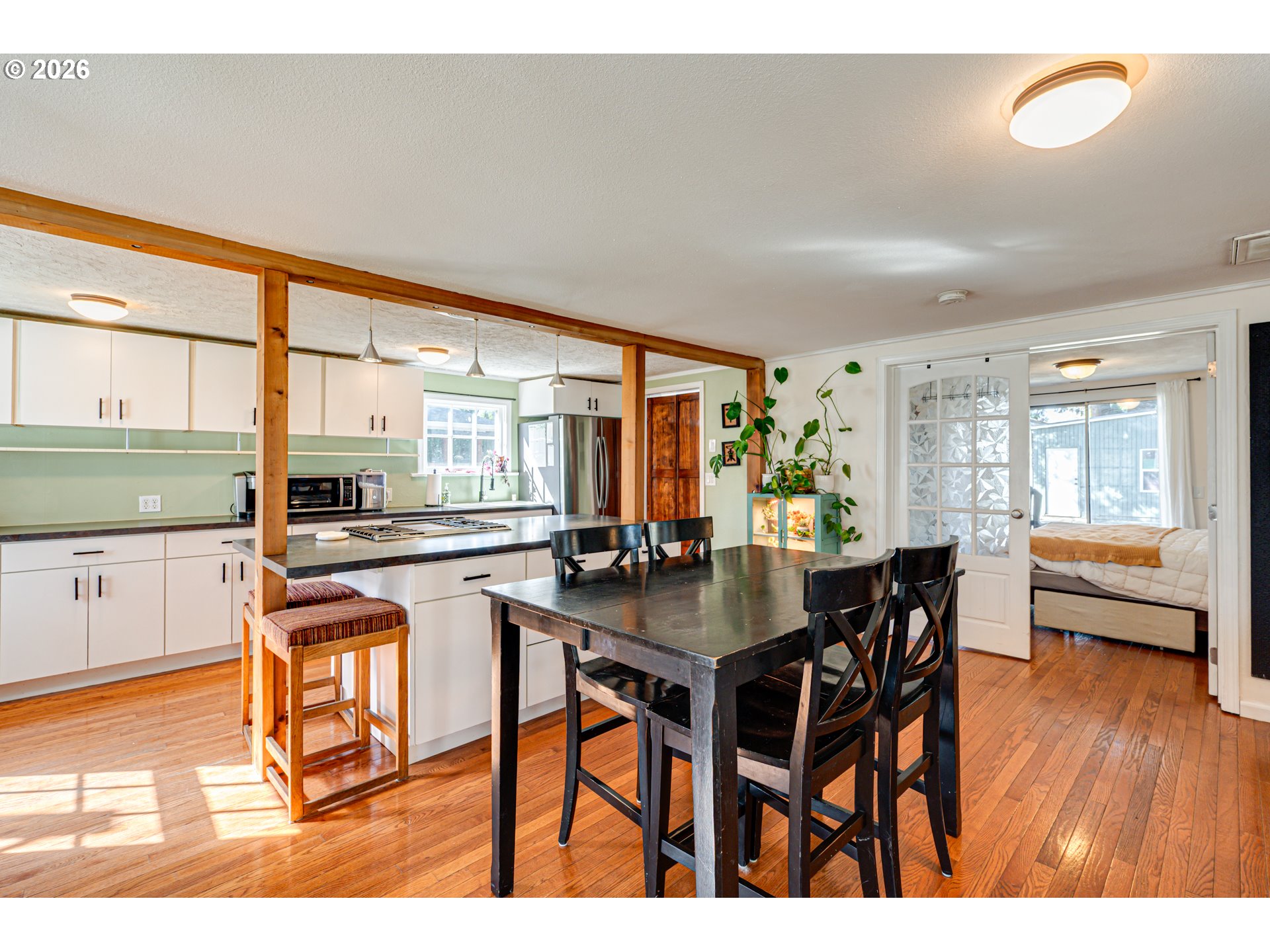 565 9th Street Washougal, WA 98671 - Photo 9 of 24 a dining hall with stainless steel appliances granite countertop a stove and white cabinets