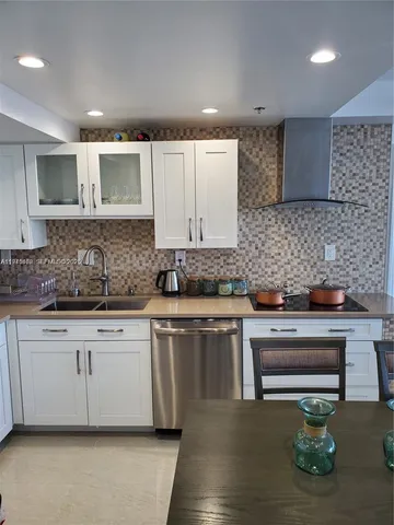 a kitchen with stainless steel appliances granite countertop a sink a stove a microwave a sink and cabinets