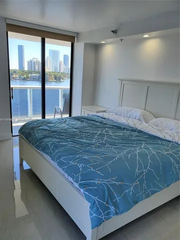 a bed sitting in a room next to a window