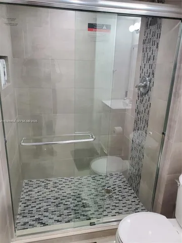 a bathroom with a shower and toilet