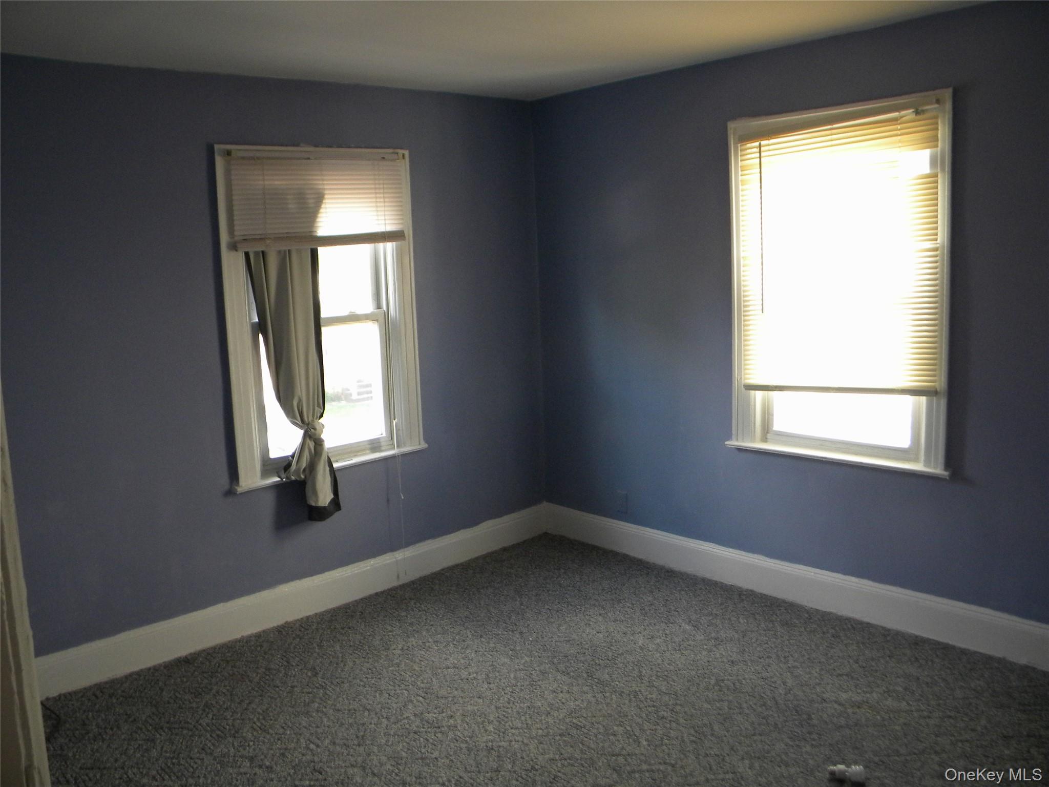 241-26 86th Road Queens, NY 11426 - Photo 18 of 38 an empty room with a window