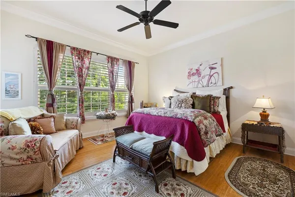 a bedroom with a bed couch and window