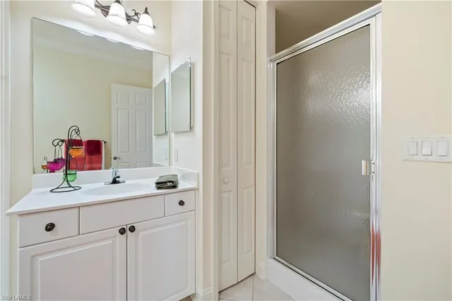 a bathroom with a sink vanity and mirror