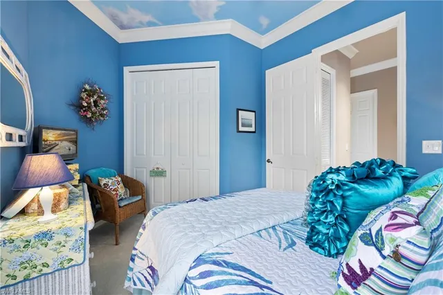 a bedroom with two bed and a painting on the wall