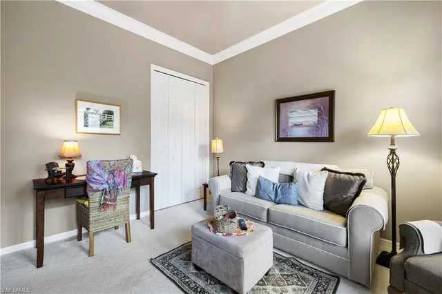 a living room with furniture and a lamp