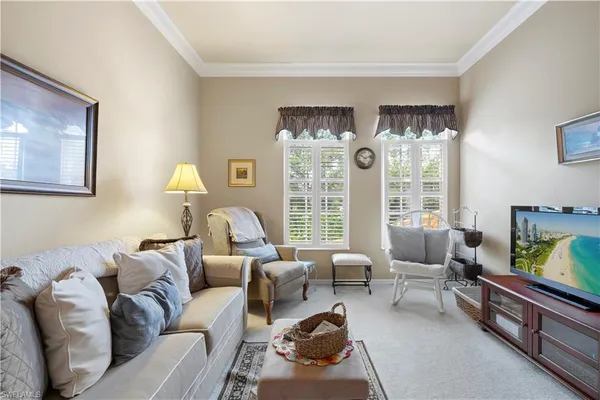 a living room with furniture large window and flat screen tv
