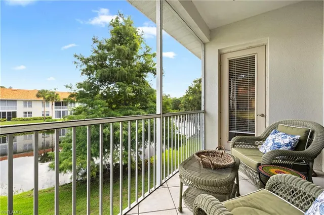 a balcony with furniture and a potted plant