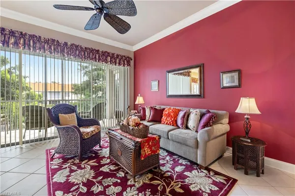 a living room with furniture and a floor to ceiling window