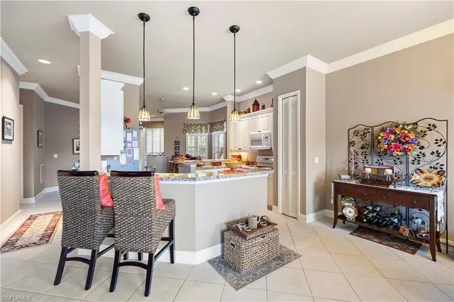 a kitchen with stainless steel appliances kitchen island granite countertop a table and chairs
