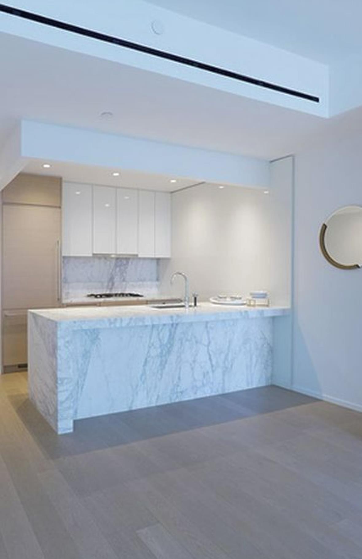 30 Riverside Boulevard, Unit 29D Manhattan, NY 10069 - Photo 6 of 25 a kitchen with kitchen island a sink counter top space and cabinets