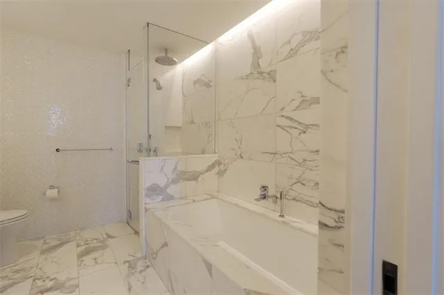 a bathroom with a bathtub and shower