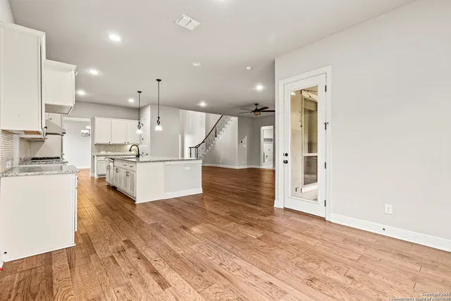 a view of kitchen with wooden floor and electronic appliances