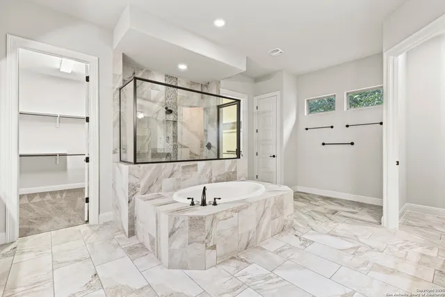 a bathroom with a bathtub and a shower