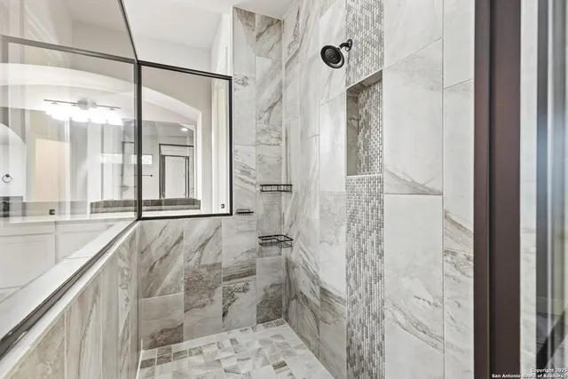 a bathroom with a shower and a sink