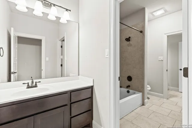a bathroom with a tub a sink shower and a mirror