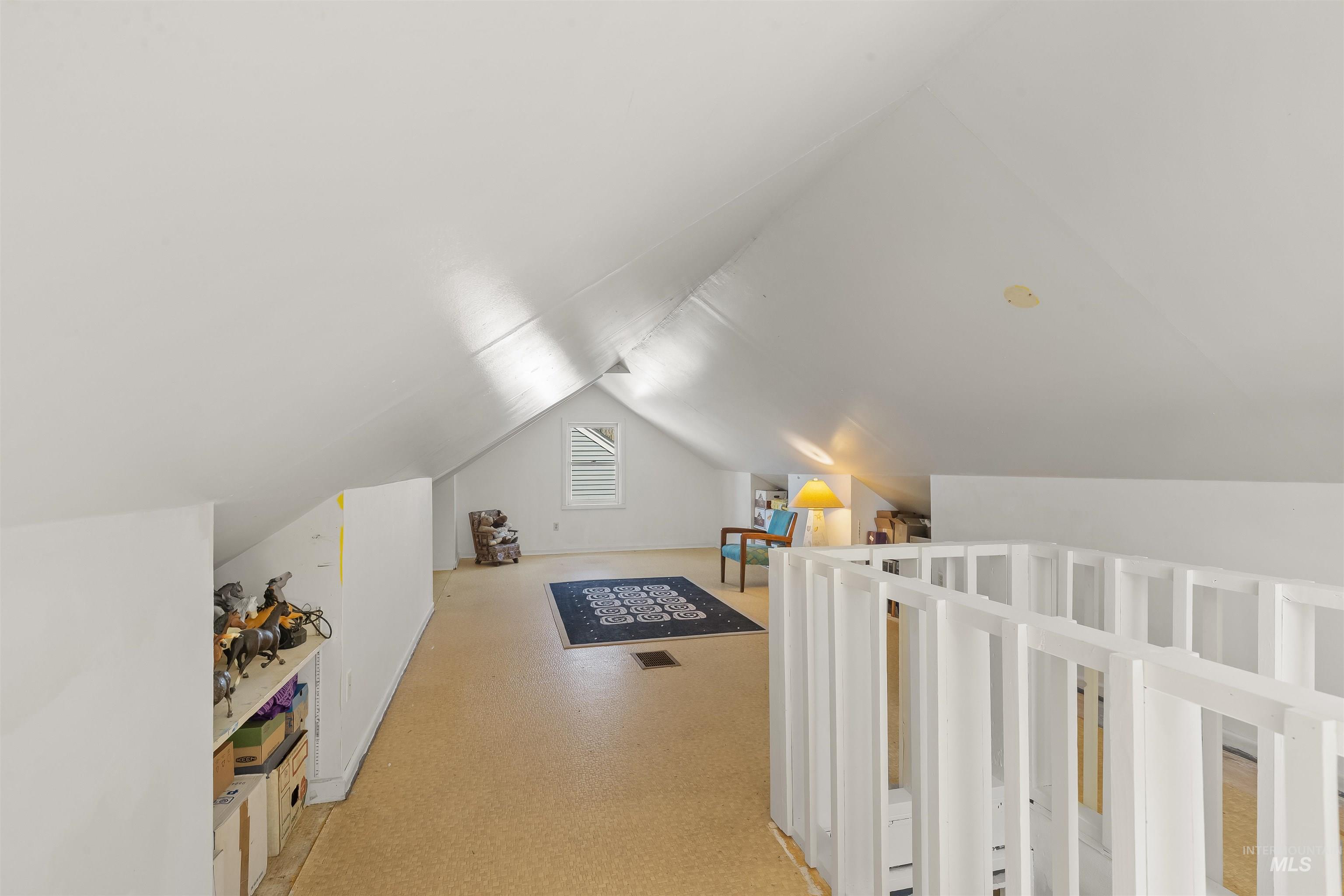 924 N Street Lewiston, ID 83501 - Photo 26 of 46 Expansive attic space featuring sloped ceilings, a louvered window, and a built-in railing