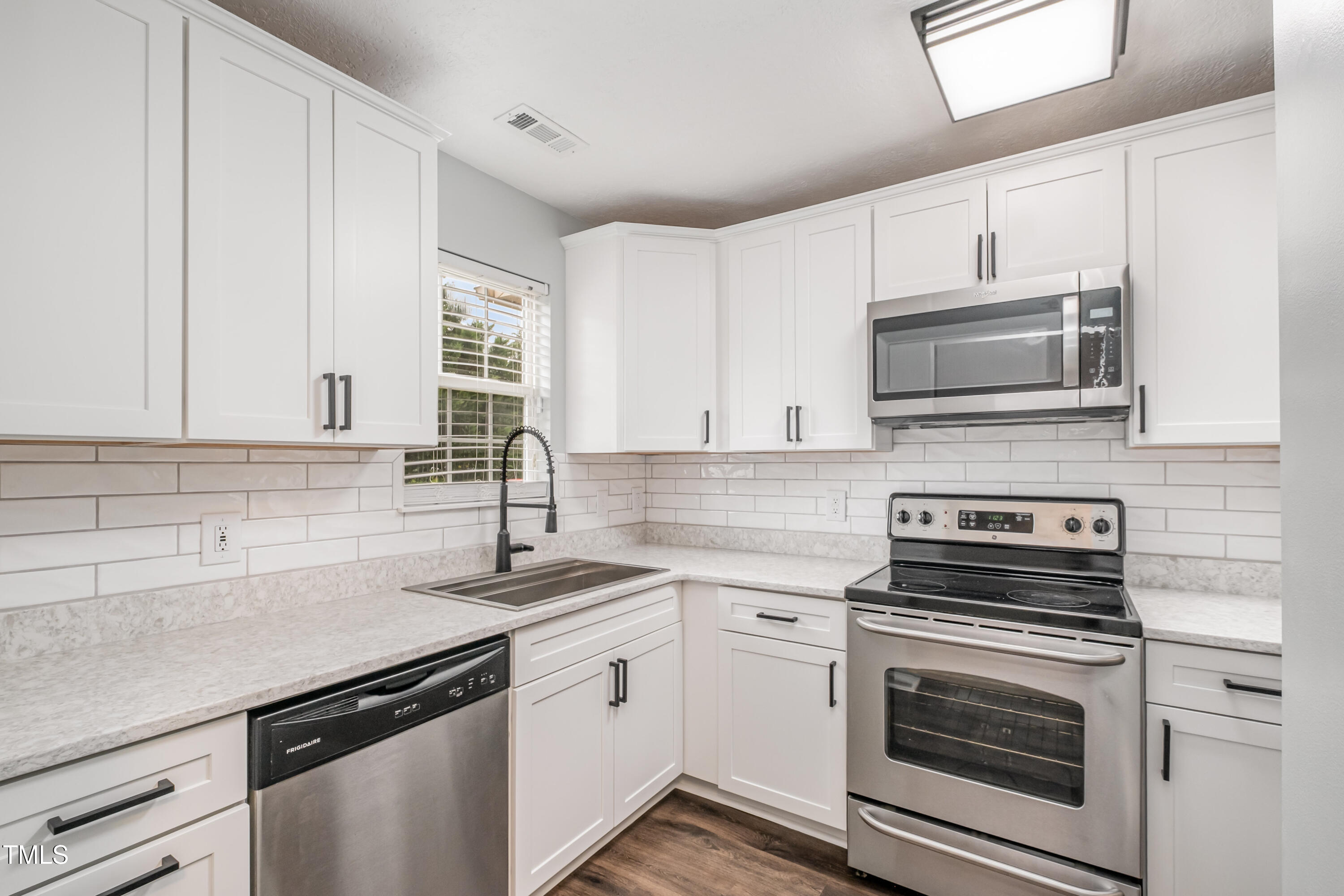 932 South 5th Street Mebane, NC 27302 - Photo 2 of 29 a kitchen with granite countertop a sink stove and microwave