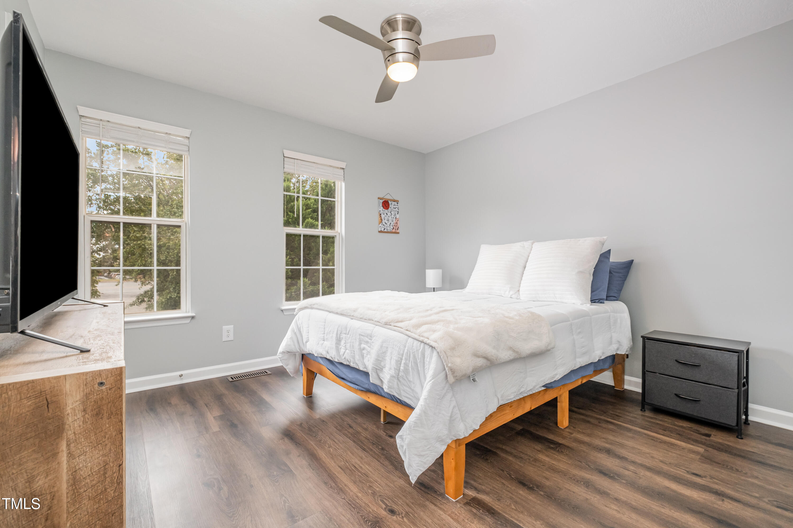 932 South 5th Street Mebane, NC 27302 - Photo 23 of 29 a bedroom with a bed a window and a flat screen television