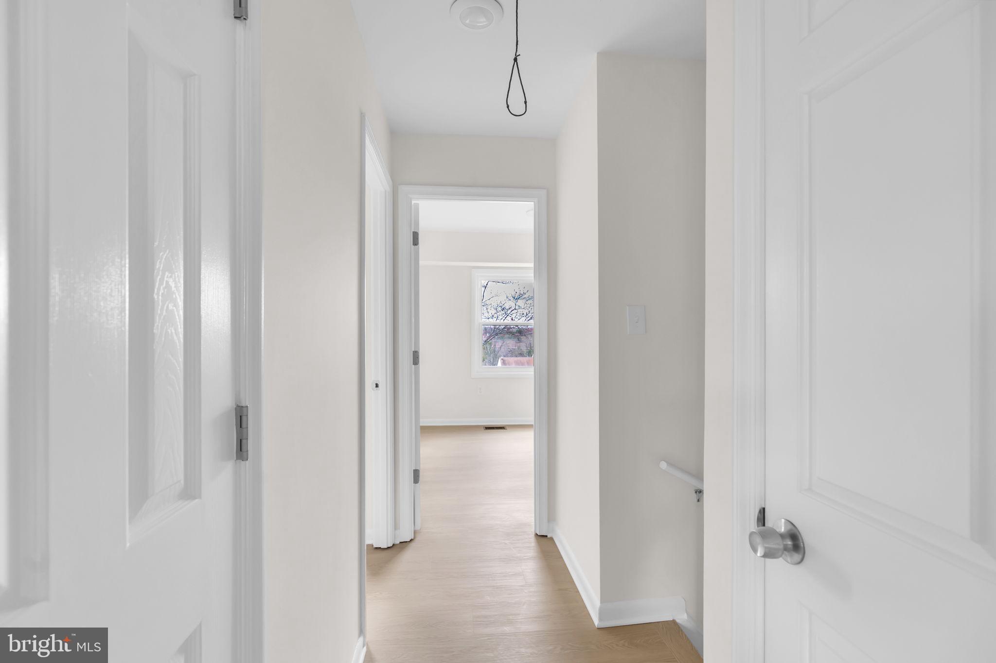 26 Timber Rock Road Gaithersburg, MD 20878 - Photo 14 of 36 a view of a hallway with wooden floor