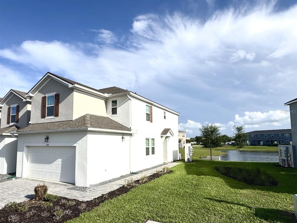 1025 Spring Palms Loop Orlando, FL 32828 - Photo 1 of 9 a front view of a house with a yard