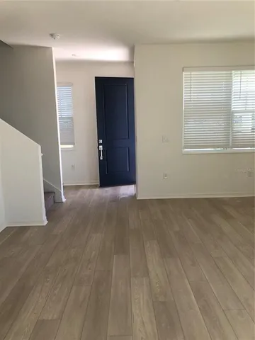 an empty room with windows and closet