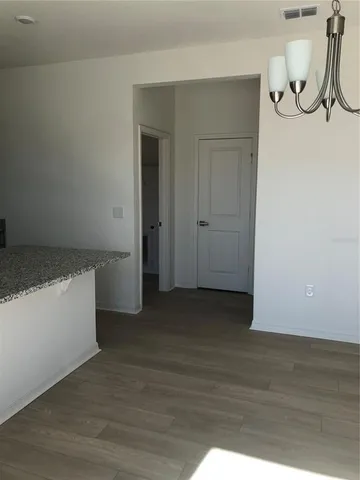 a view of a room with wooden floor