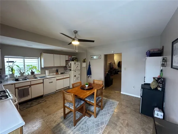 a living room with stainless steel appliances kitchen island granite countertop furniture and a view of kitchen