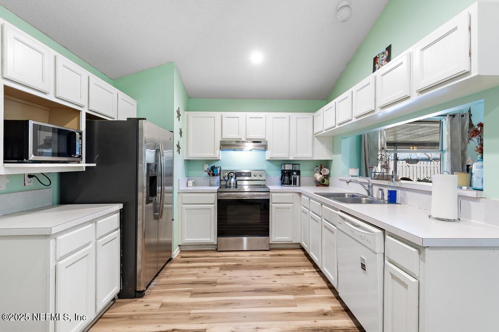 83096 St Mark Drive Yulee, FL 32097 - Photo 13 of 35 a kitchen with a sink stove and refrigerator