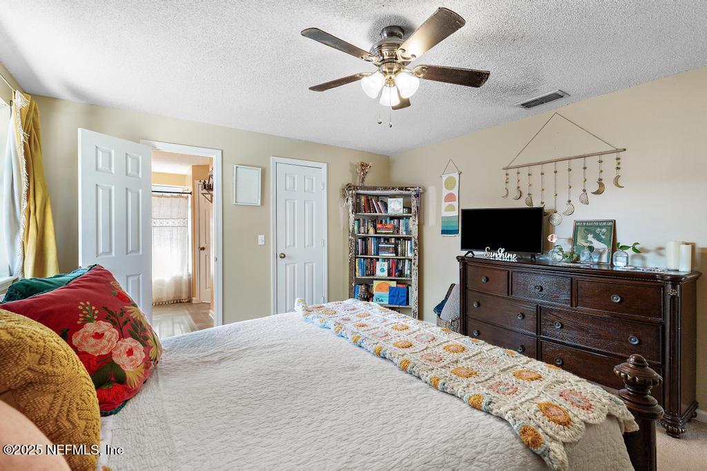 83096 St Mark Drive Yulee, FL 32097 - Photo 17 of 35 a bedroom with a bed and a flat screen tv