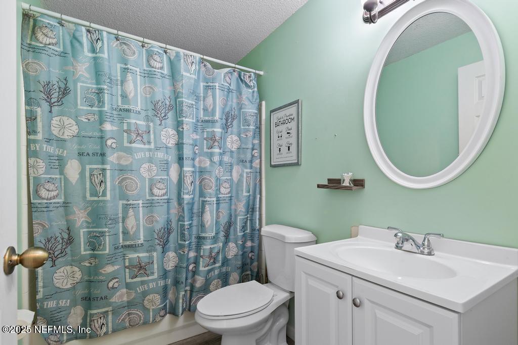 83096 St Mark Drive Yulee, FL 32097 - Photo 20 of 35 a bathroom with a sink a toilet and a mirror
