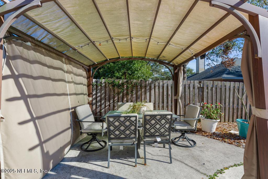 83096 St Mark Drive Yulee, FL 32097 - Photo 27 of 35 a view of patio with a table and chairs and wooden fence