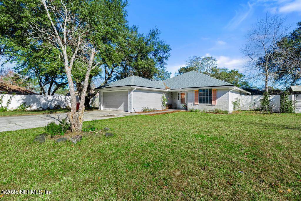 83096 St Mark Drive Yulee, FL 32097 - Photo 3 of 35 a white house with a big yard and large trees