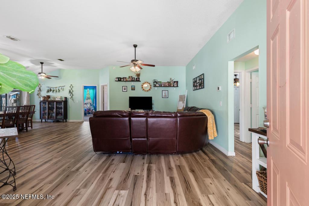 83096 St Mark Drive Yulee, FL 32097 - Photo 5 of 35 a living room with furniture and a chandelier
