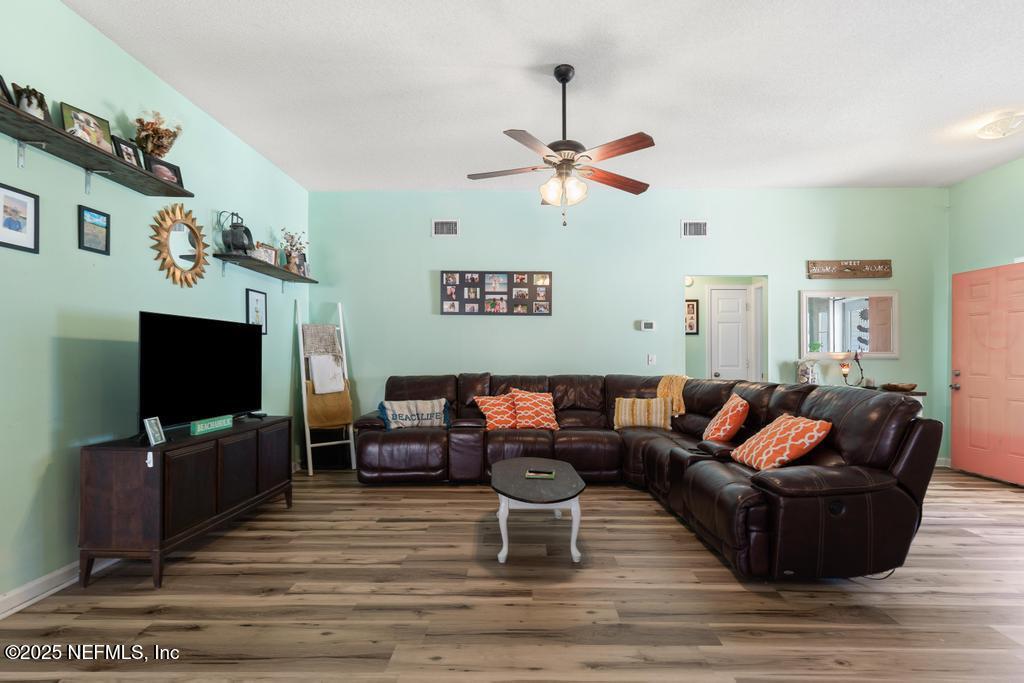 83096 St Mark Drive Yulee, FL 32097 - Photo 8 of 35 a living room with furniture and a flat screen tv