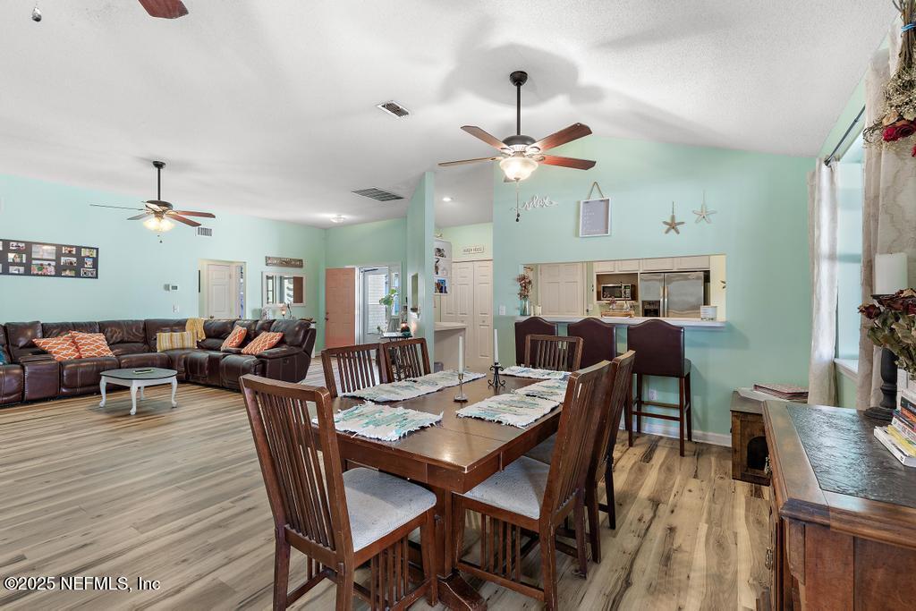 83096 St Mark Drive Yulee, FL 32097 - Photo 10 of 35 a view of a dining room and livingroom with furniture a rug a chandelier and wooden floor