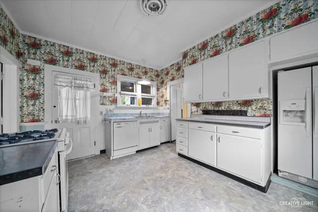 a kitchen with cabinets and window