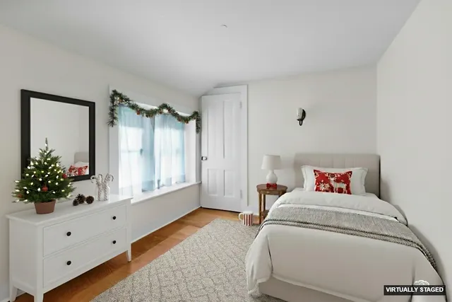 a room with a bed couch and a window