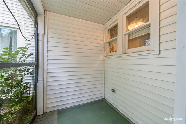 a view of a house with a yard and large trees