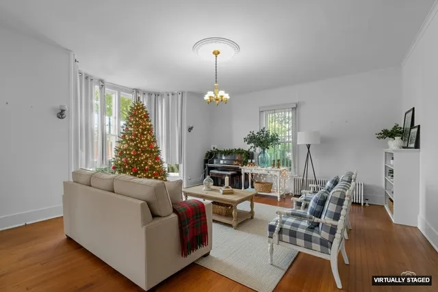 a living room with furniture and a chandelier