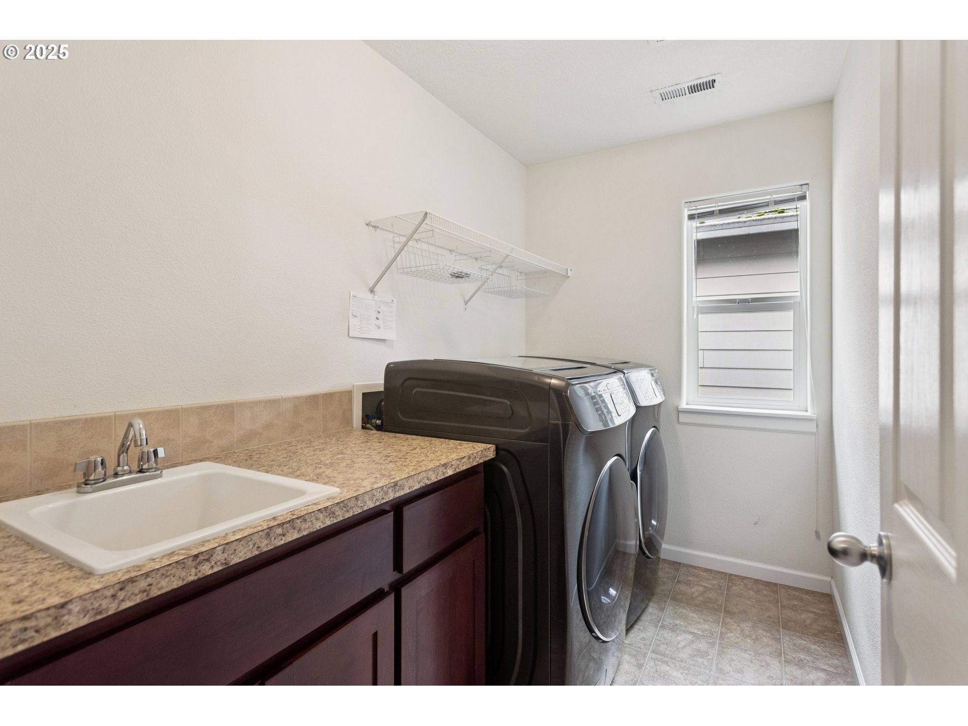 18232 Southwest Orlov Court Beaverton, OR 97078 - Photo 15 of 15 a utility room with a sink dryer and washer