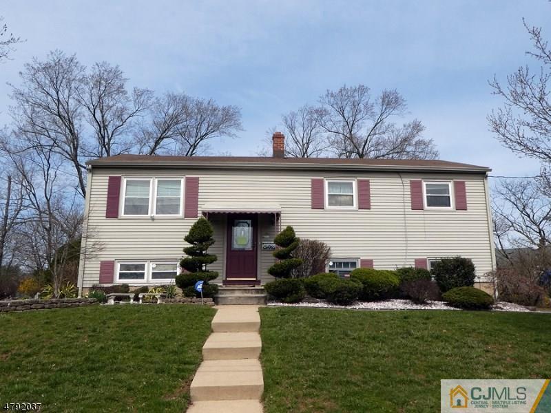 4 Lexington Road Somerset, NJ 08873 - Photo 1 of 14 a front view of a house with a garden and yard