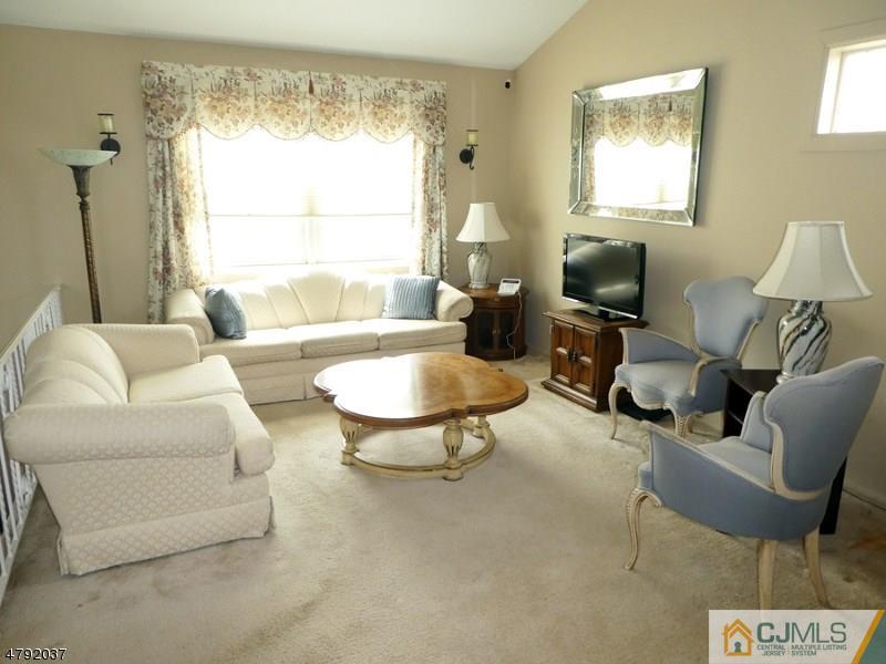 4 Lexington Road Somerset, NJ 08873 - Photo 2 of 14 a living room with furniture a table and a flat screen tv