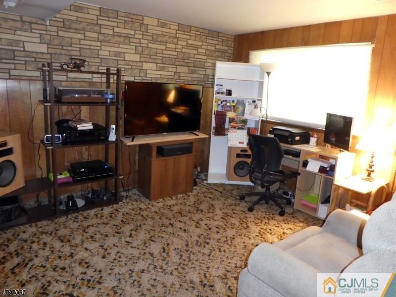 4 Lexington Road Somerset, NJ 08873 - Photo 11 of 14 a living room with furniture a flat screen tv and a fireplace