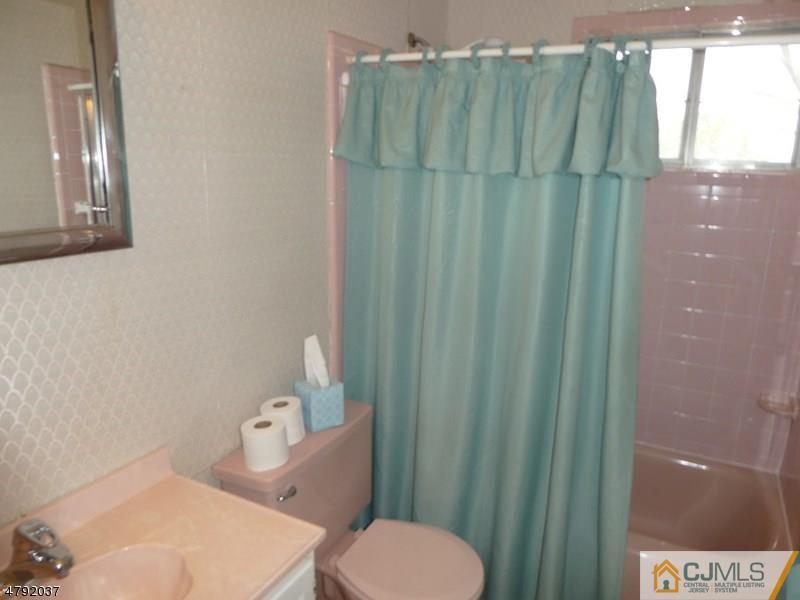 4 Lexington Road Somerset, NJ 08873 - Photo 5 of 14 a white toilet sitting next to a shower curtain