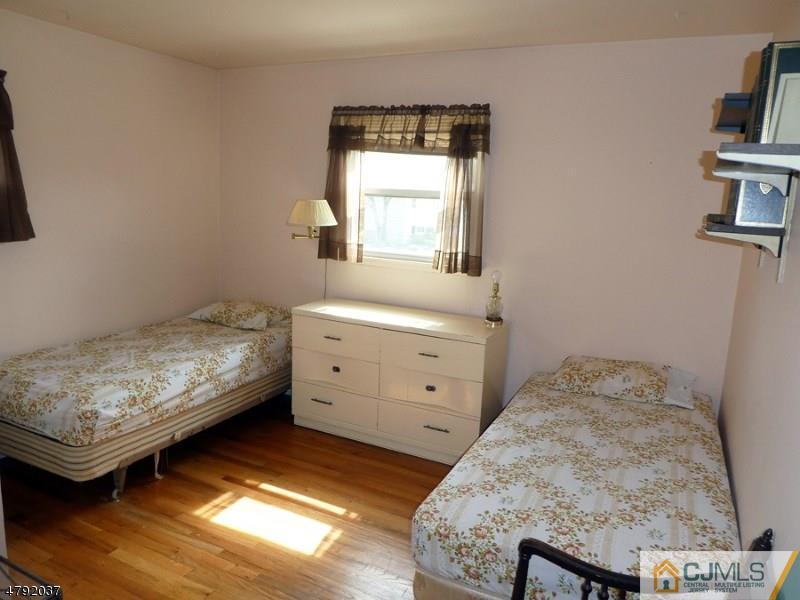 4 Lexington Road Somerset, NJ 08873 - Photo 9 of 14 a bedroom with a bed and a window
